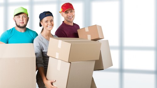 Local removals crew loading items into a van